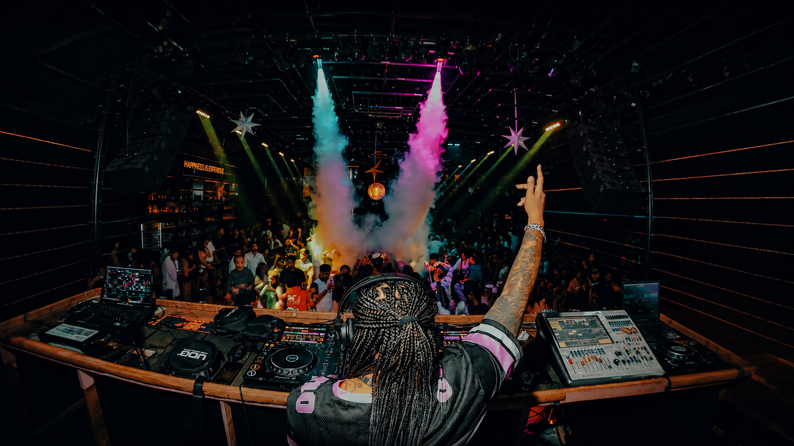 DJ Kim performing live before a packed crowd